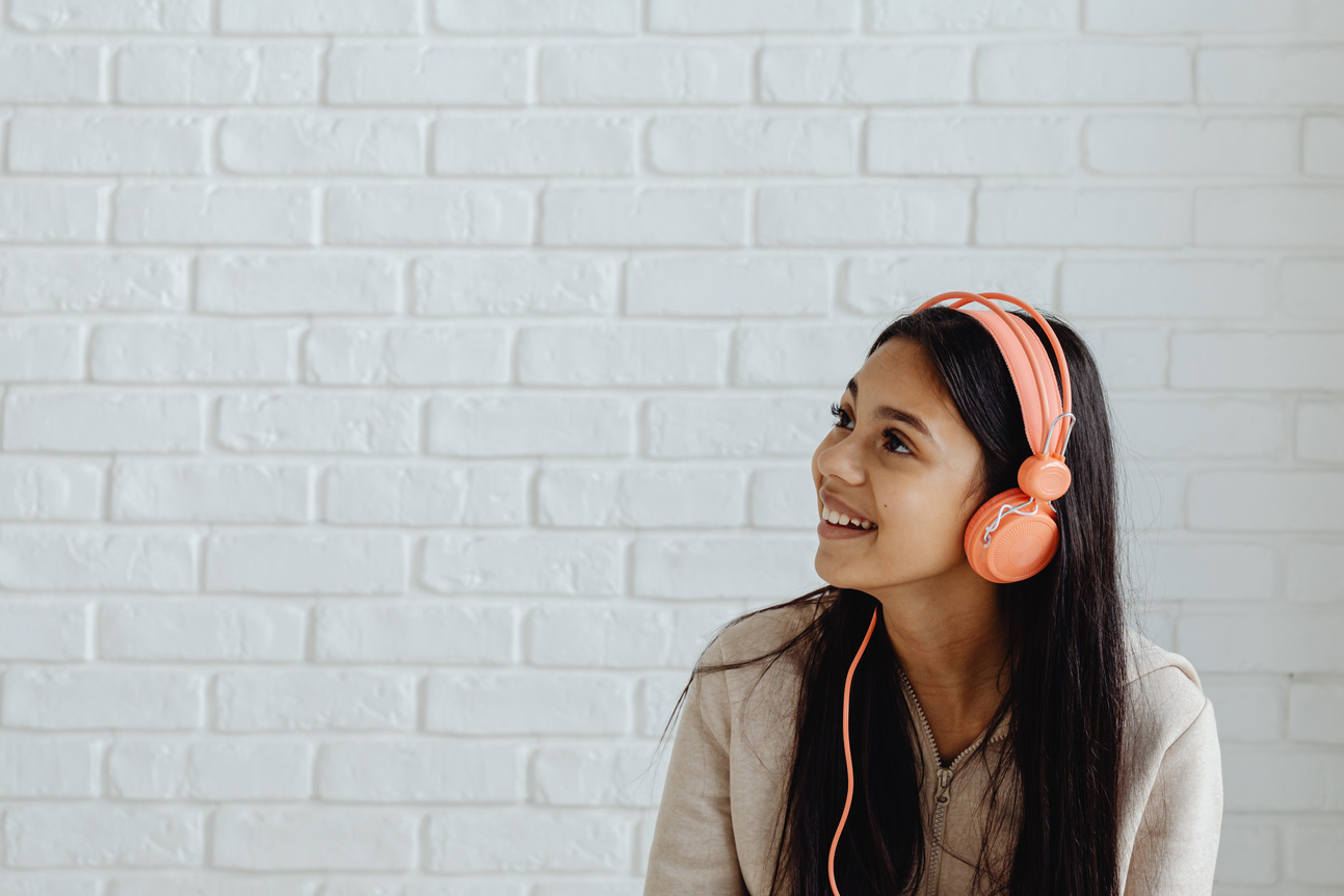 Smiling Female Teenager Listening to Music